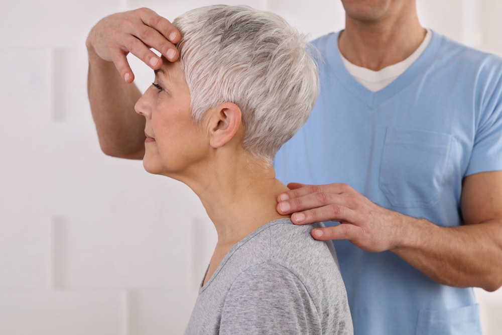 Osteopath treating elderly patient