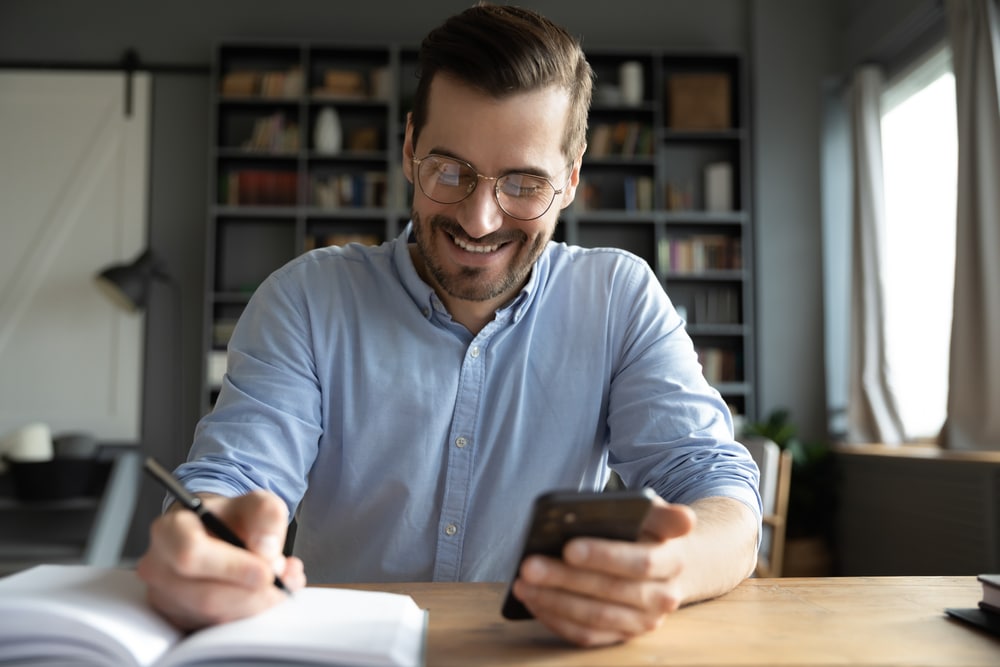 Man using smartphone to book appointment