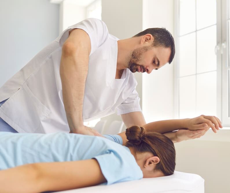 Osteopath treating female patient