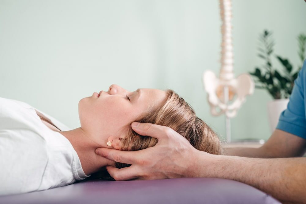 Woman receiving cranial osteopathy