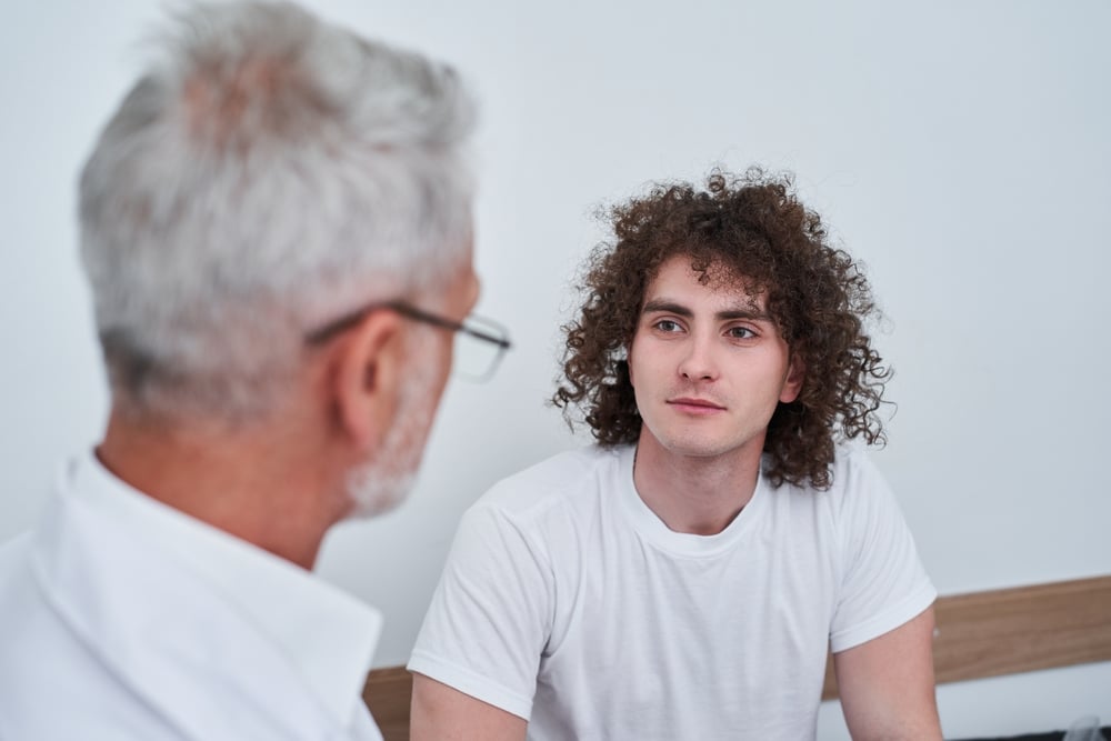 Osteopath consulting with patient