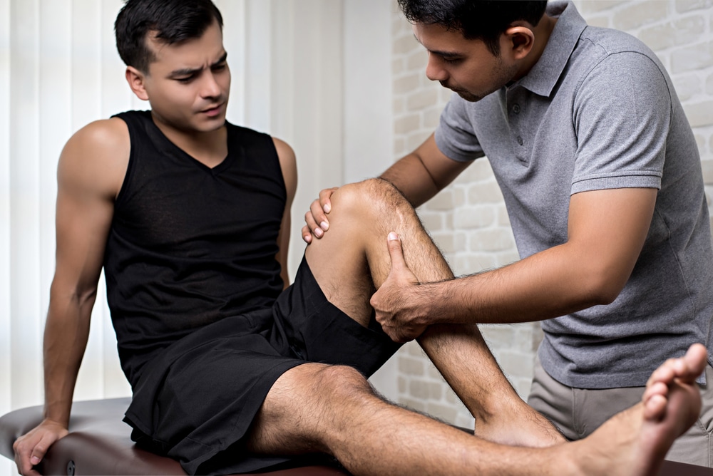 Osteopath treating knee pain