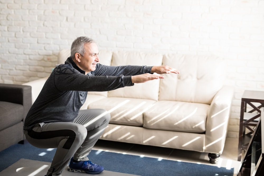 Man doing exercise in living room