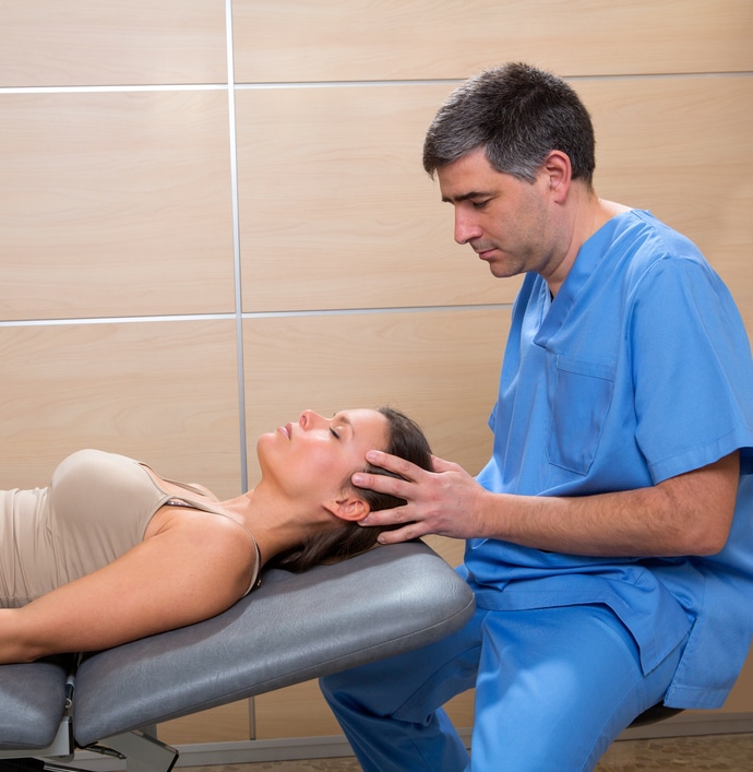 Woman receiving cranial osteopathy treatment