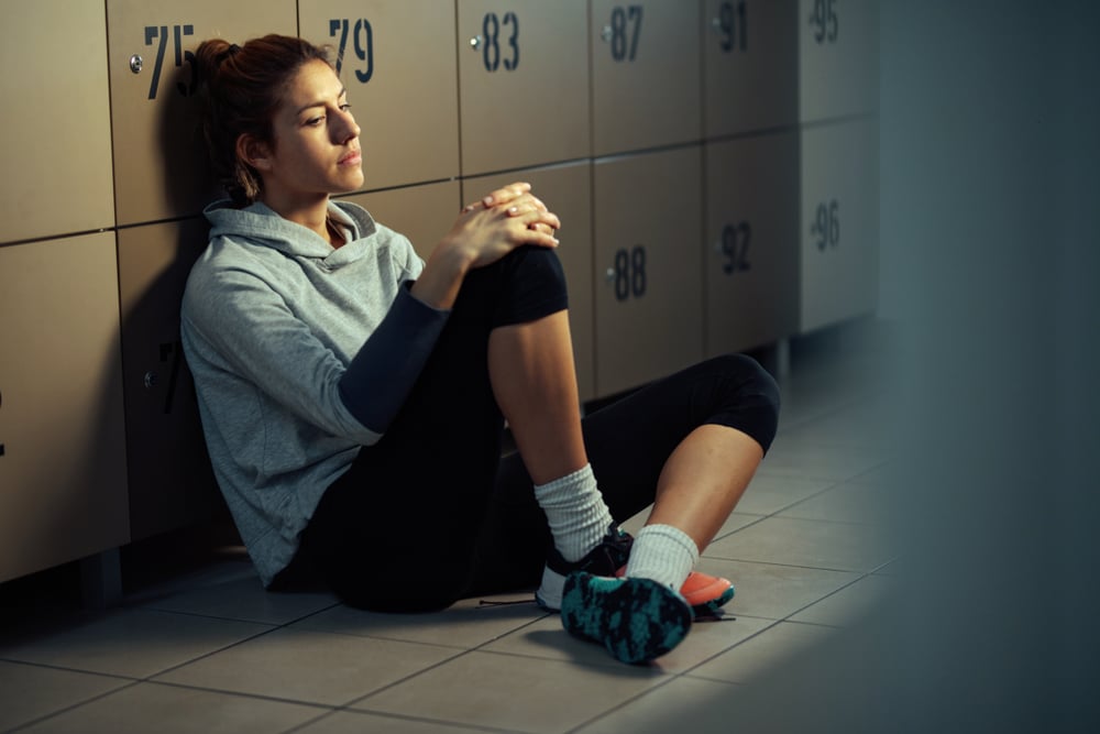 Woman in locker room depressed