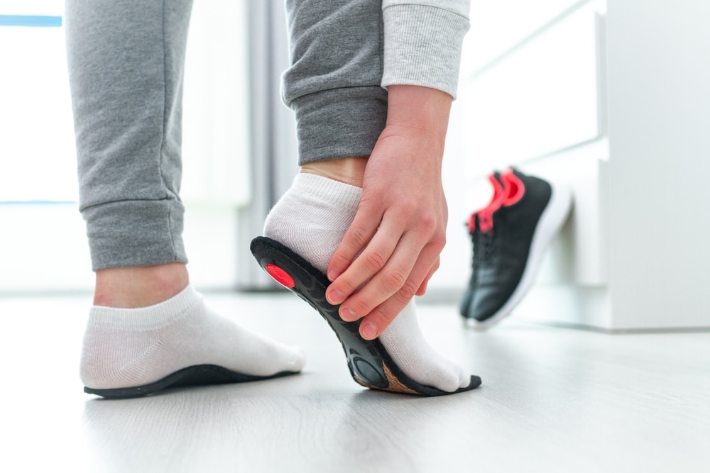 Person holding insole to their foot