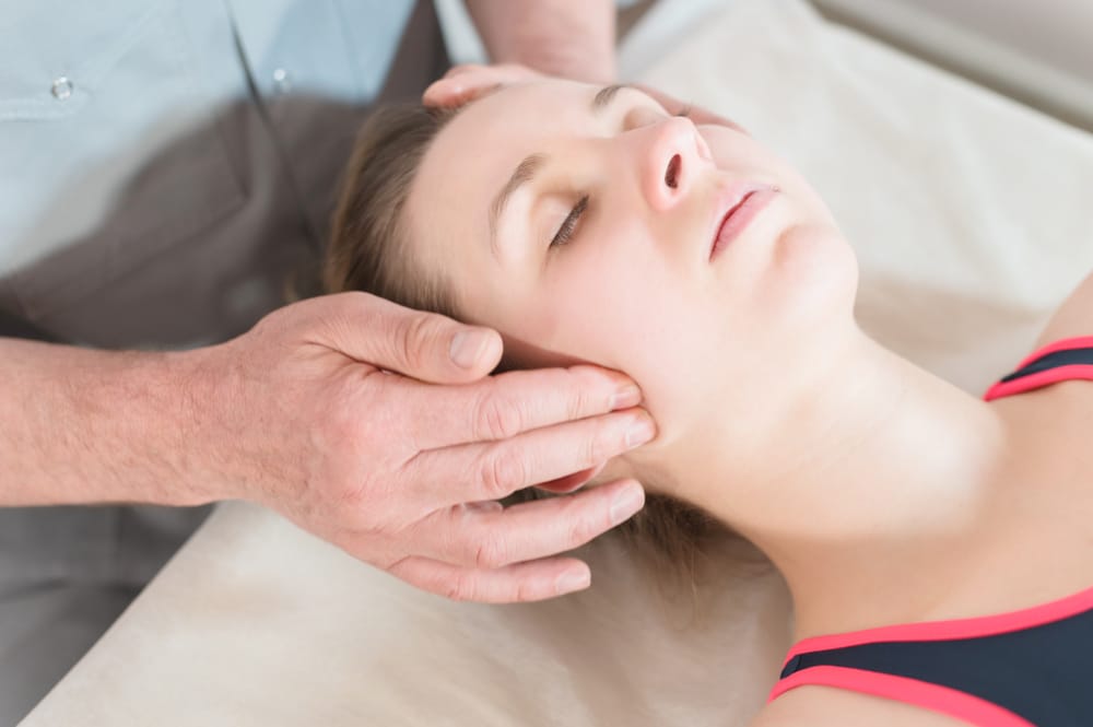 Osteopaths treating women for headache