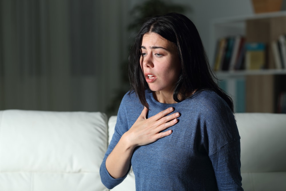 Woman with hand on chest due to anxiety