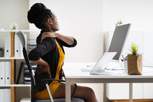 Woman holding her shoulder in pain