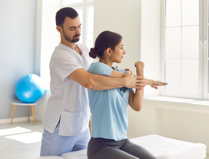 Osteopath treating female patient