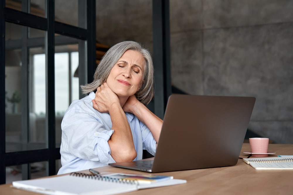 Woman with neck pain from using laptop