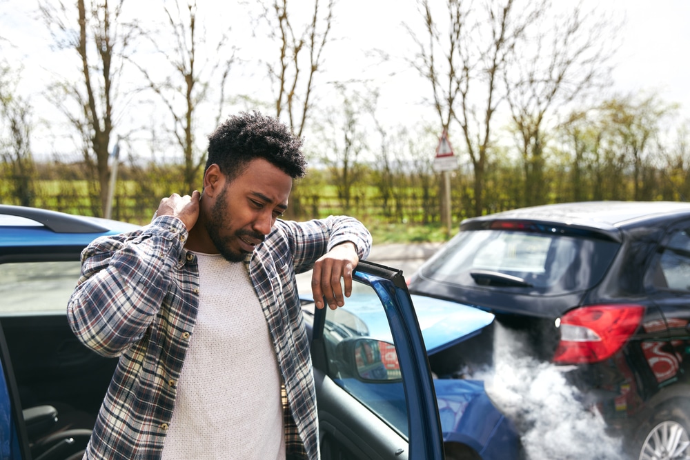 Man holding neck after car crash