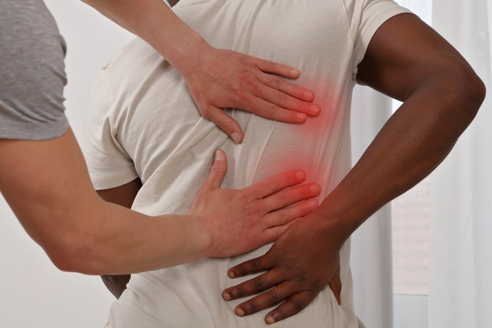 Osteopath treating person with back pain