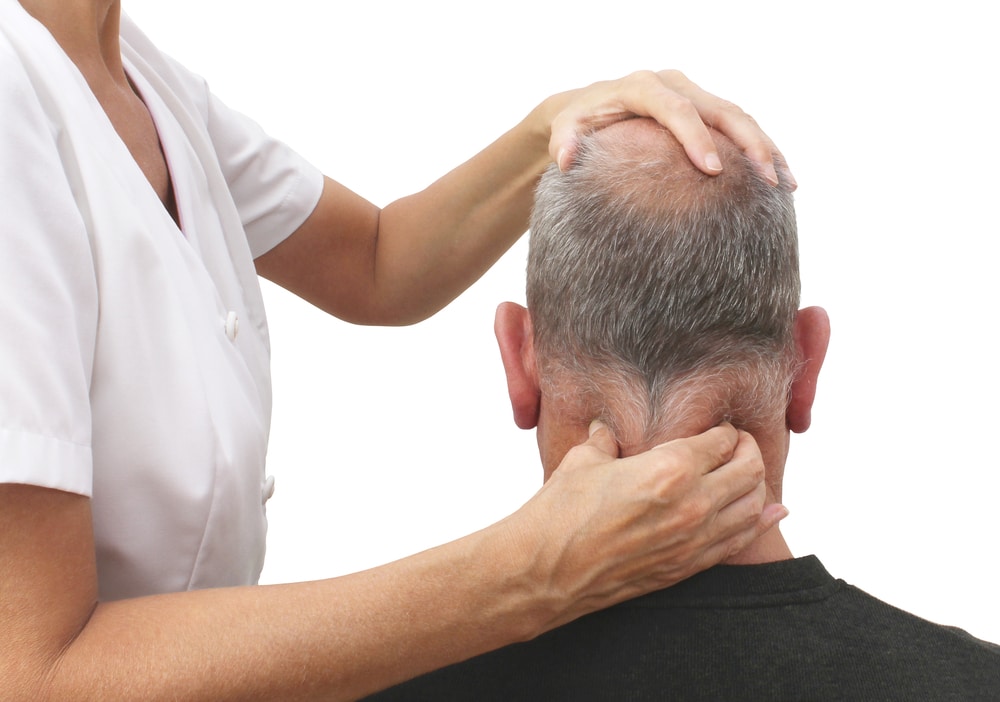 Female osteopath treating patient with neck pain