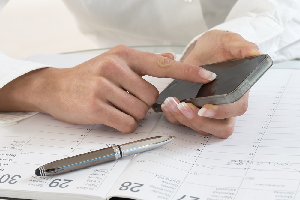 Person booking appointment with smartphone