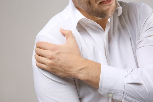 Man holding shoulder in pain