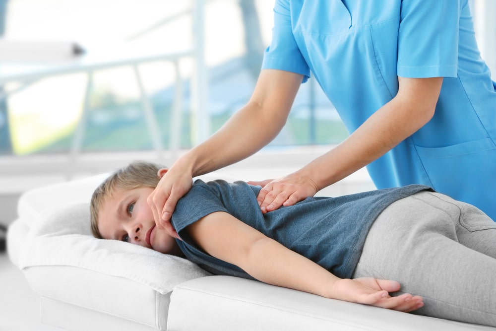 Osteopath treating a child