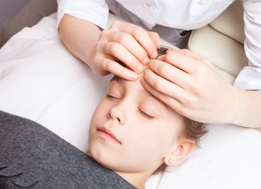 Osteopath treating a child