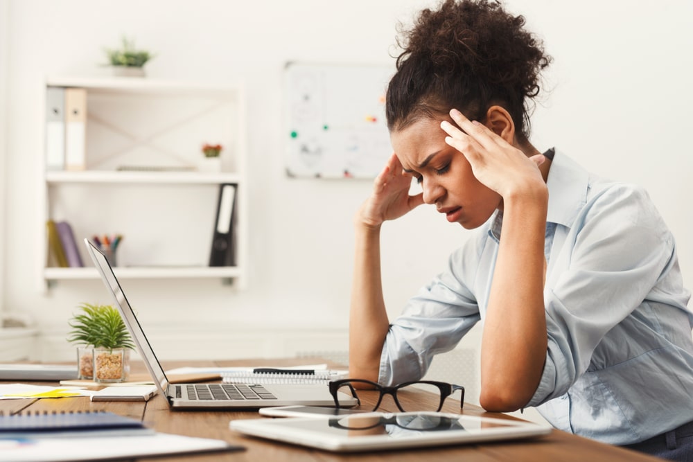 Woman at desk with headache